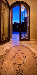 The benefits of mosaic floor tiles. Mediterranean Inspired Foyer With Tall Arched Door And Inlaid Mosaic Tile Floor Hgtv