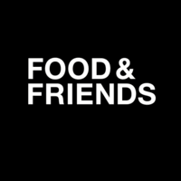 Friends sitting at table with food and projector in room interiorn. Food Friends Linkedin