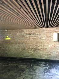 Slatted Ceiling In Basement Joists Cables Pipes And Subfloor Painted Black With Furring Stri Basement Ceiling Painted Basement Ceiling Basement Remodel Diy