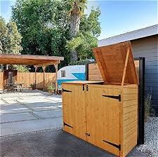 Look for models that are on wheels so you can roll your trash can to the curb without straining. Wooden Trash Can Holders Conceal Your Garbage Cans Outsidemodern