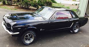 What was the price of a mustang in 1965? 1965 Mustang Coupe Black With Red Interior Ford Daily Trucks