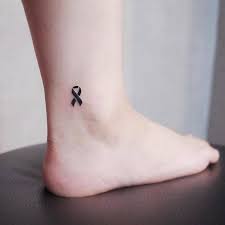 Cancer ribbon tattoos are worn for different purposes. Black Ribbon Tattoo On The Ankle Cancer Ribbon Tattoos Pink Ribbon Tattoos Awareness Ribbons Tattoo