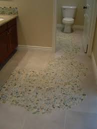 To make the installation of pebbles on a floor simple, retailers offer pebbles attached to mesh. Flooring Creations Design Gallery Stone Floor Bathroom Bathroom Flooring Mosaic Tile Bathroom Floor