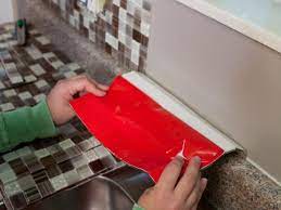 So when it came time to tackle the weird wood vinyl backsplash, gater planned to have her contractor install white ceramic subway tiles. How To Install A Backsplash How Tos Diy