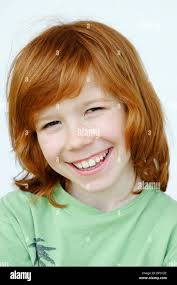 Boy, 10, with long hair, smiling Stock Photo