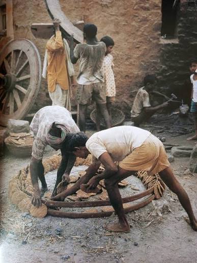 Old picture of Madras women carrying cow dung.