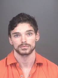 Man who stripped in tattoo shop, fled police arraigned