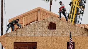 Workers building a new home as mortgage rates pressure the housing market