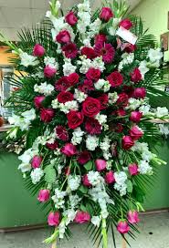 Flowers not only accompany us in the bright and joyful moments of our lives, but also in sad moments, such as a funeral or a celebration of life. Deep Maroon Sympathy Spray Easel Roses Daisies Gladiolas By Andes Florist