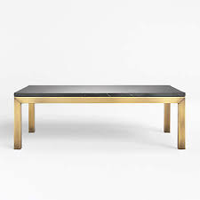 Crafted of solid pine wood, this coffee table strikes a rectangular silhouette featuring plank panel construction, recessed paneling, blackened hardware, and four chunky legs. Parsons Black Marble Top Brass Base 48x28 Small Rectangular Coffee Table Reviews Crate And Barrel