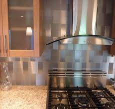 The textured reflective surface of this stainless steel backsplash changes with the intensity and direction of the light for a modern organic design. 29 Stainless Steel Backsplash Ideas Leave You Spellbound Stainless Backsplash Stainless Steel Kitchen Backsplash Stainless Steel Backsplash