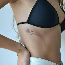 Some rib cage tattoos span the whole gut. Small Beautiful Tattoo Of A Rose Inked On The Right Rib Cage Rose Tattoos For Women Tiny Rose Tattoos Rib Tattoos For Women