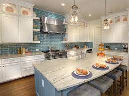 And taking the backsplash all the way to the ceiling brings the final look up a notch. White Kitchen Cabinets With Blue Subway Tile Backsplash