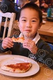 39359571-Ethan, six, from Fakenham Infant and Nursery School enjoying his  pizza at the Crown. Picture: DENISE BRADLEY