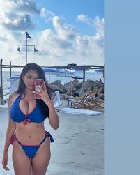 Tara Yazdi Is An Busty Brunette Displaying Her Curves In Various Bikinis