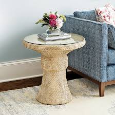 The nightstand features wicker rattan weaving throughout with vertical wooden details on the drawer for contrast. Bali Round Hand Woven Rattan Glass Side Table