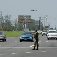 SPC Mike Armstead from the 437th Military Police Company, Fort Belvoir,  Virginia, helps direct traffic after Hurricane Andrew knocked out power to  the area