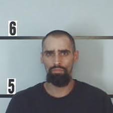 Local man charged with breaking into vehicle