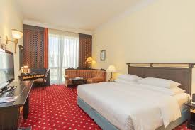 Set two stacking patio chairs beside a metal outdoor side table to create a simple balcony retreat. Millennium Airport Hotel Dubai Dubai 2021 Updated Prices Deals