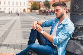 If looking cool is your fashion goal, then styling simple men's denim shirt outfit probably won't help. Side View Of Seated Relaxed Man Wearing Denim Shirt And Red Sunglasses Stock Photo Picture And Royalty Free Image Image 115182533