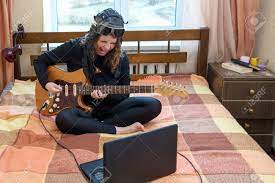 Maybe you would like to learn more about one of these? Girl Playing Electric Guitar Sitting On The Bed In The Bedroom Stock Photo Picture And Royalty Free Image Image 100932120