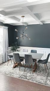 This dining area offers a wooden rectangular table that matches the bench beside it. Dark Gray Dining Room In 2021 Dark Dining Room Grey Dining Room Dining Room Colors