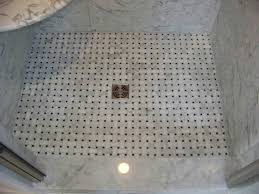 Black and white bathroom with an orb towel holder mounted on white staggered bath wall tiles. Carrara Marble Floor Tile Bathroom Novocom Top