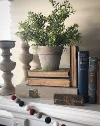 January Mantle With Old Books A Plant And Fuzzy Ball Garland Farmhouse Farmhouse Mantle Decor French Country Decorating Mantle Decor