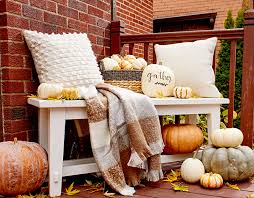 Here, you can see a three chaise lounge chairs, a dining area, a seating area in the foreground, and a relaxing bench to the far right. 15 Festive Fall Porch Ideas You Ll Want To Copy Asap Better Homes Gardens