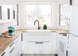 Black stained wood cabinetry combined with natural wood accents give this contemporary cooking space by the interior designers at let's talk kitchens a. Bright And Welcoming Kitchen Makeover White Gloss Kitchen Glossy Kitchen Small White Kitchens