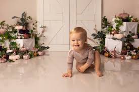 Another great first birthday photoshoot idea is to dress your baby up in a cute outfit. Lea Cooper Photography