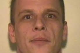 Wanted man found with gun and ammo in his car