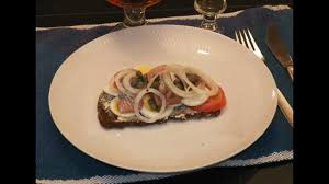 It is prepared with buttered rye bread that is typically topped with this danish sandwich consists of a bun that is filled with thinly sliced flæskesteg—a traditional pork roast with a crispy rind. Smorrebrod Danish Open Face Herring Sandwich A Matjes Herring Sild Sandwich For Lunch Dinner Youtube