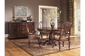 The North Shore Dining Table From Ashley Furniture Homestore Afhs Com A Deep Rich Stain Round Pedestal Dining Table Dining Room Sets Round Dining Room Table