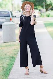 Solid Black Cropped Leg Jumpsuit Paired With Chunky Heels And A Panama Style Hat Flattering Fashion Classy Outfits Inexpensive Dresses