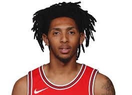 The image shows cameron standing behind a mic in a recording studio with her hair pulled back in a tight, low. Cameron Payne Basketball Index