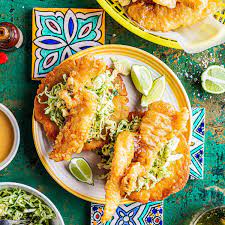 This easy fish taco recipe from delish.com will get on swimmingly with your guests. Baja Fish Tacos With Herbed Mojo De Ajo Slaw Recipe Spinneys Uae