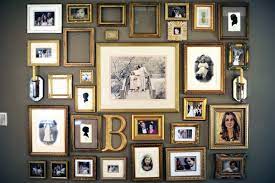 Display empty frames above the fireplace mantel. How To Arrange A Photo Wall Tips And Creative Ideas