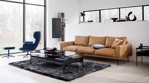 This coffee table has a white, marble table top and sleek, black metal legs. How To Choose A Coffee Table In 7 Easy Steps Tlc Interiors