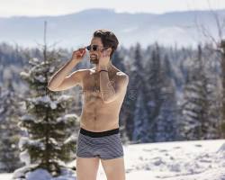 Image of someone wearing shorts and sunglasses in the snow