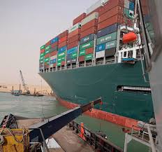 The ship started moving wednesday after being refloated and moved to the side of the waterway, a shipping source and a in this photo released by the suez canal authority, a boat navigates in front of a massive cargo ship, named the mv ever given, rear, sits grounded. Obqfo Zrzz Fqm
