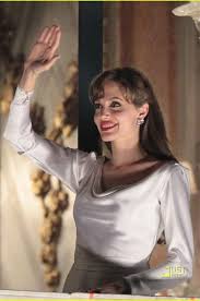 The outfit makes her look extremely elegant and accentuates her beauty in a timeless manner. Angelina Jolie White Long Sleeve Plunging Cowl Neck Celebrity Dress The Tourist Movie