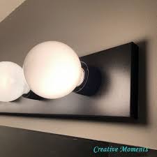It can be wider than your bathroom mirrors , though. Bathroom Vanity Light Updated With Spray Paint Super Simple In 2021 Vanity Light Update Lighting Makeover Bathroom Light Bar
