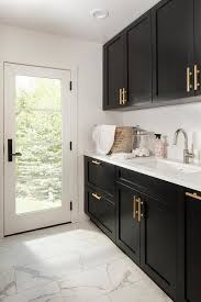 Consider other feature elements of your kitchen design when choosing the finish (and style) of your handles. Black Shaker Laundry Room Cabinets With Brushed Gold Pulls Transitional Kitchen