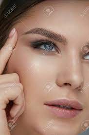 Beauty Face Makeup Woman With Beautiful Eyes And Eyebrows Make Up Closeup Girl Model Lifting Eye Skin With Finger Stock Photo Picture And Royalty Free Image Image 124524169