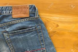 Get the best deals on mens back flap pocket jeans and save up to 70% off at poshmark now! Blue Jeans With Back Pocket And Brown Leather Tag On Wood Table Background Stock Photo Picture And Royalty Free Image Image 40782333