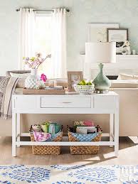 This high console table has a very thick and sturdy dark wood top that is installed at the same height as the back of the couch. Reasons Your Living Room Needs A Sofa Table Better Homes Gardens