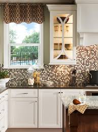 Custom handmade glass mosaic backsplash with typhoon bordeaux granite countertop and destin color mocha glazed white cabinets. 18 Gleaming Mosaic Kitchen Backsplash Designs