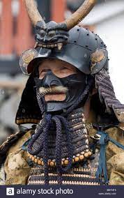 Man dressed in full samurai armor complete with kabuto helmet and mempo  face mask to intimidate the enemy Stock P… | Samurai armor, Samurai helmet,  Japanese warrior