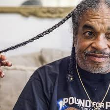 Part of his identity: ex-Central PG still growing hair